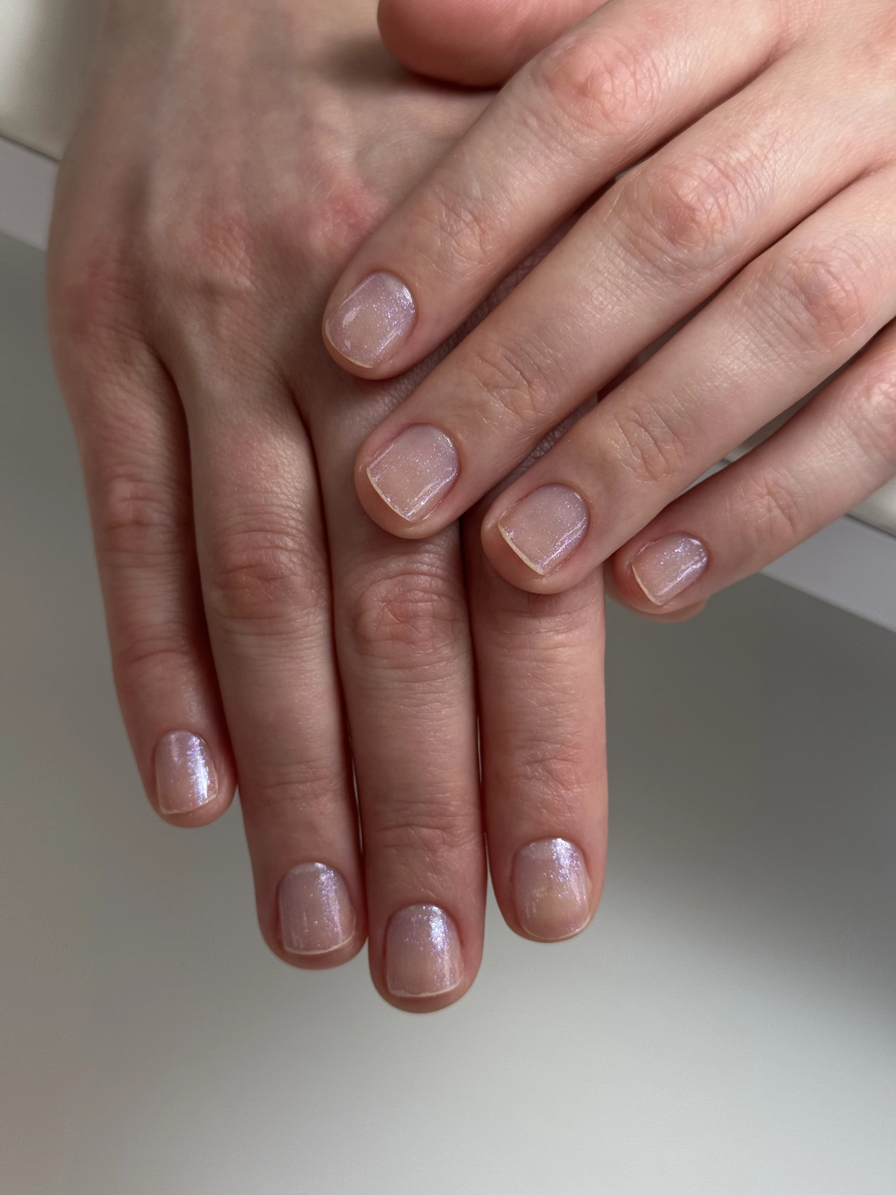 Iridescent sheer pink regular polish on squoval nails layered softly, applied at My Beauty Space nail studio in Mississauga.