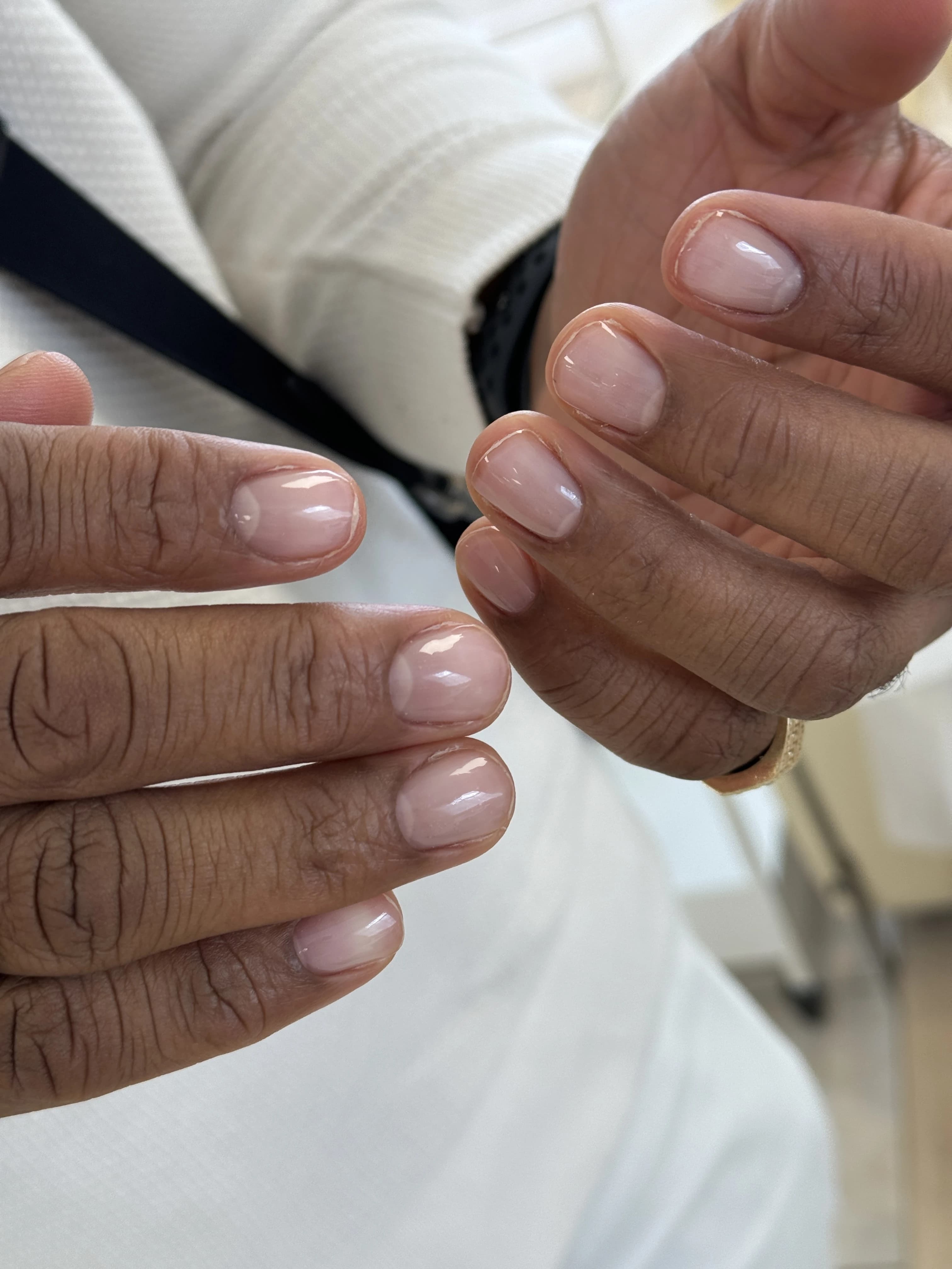 Sheer nude polish on short rounded men's nails with a pavé gold band, men's mani at My Beauty Space in Mississauga.