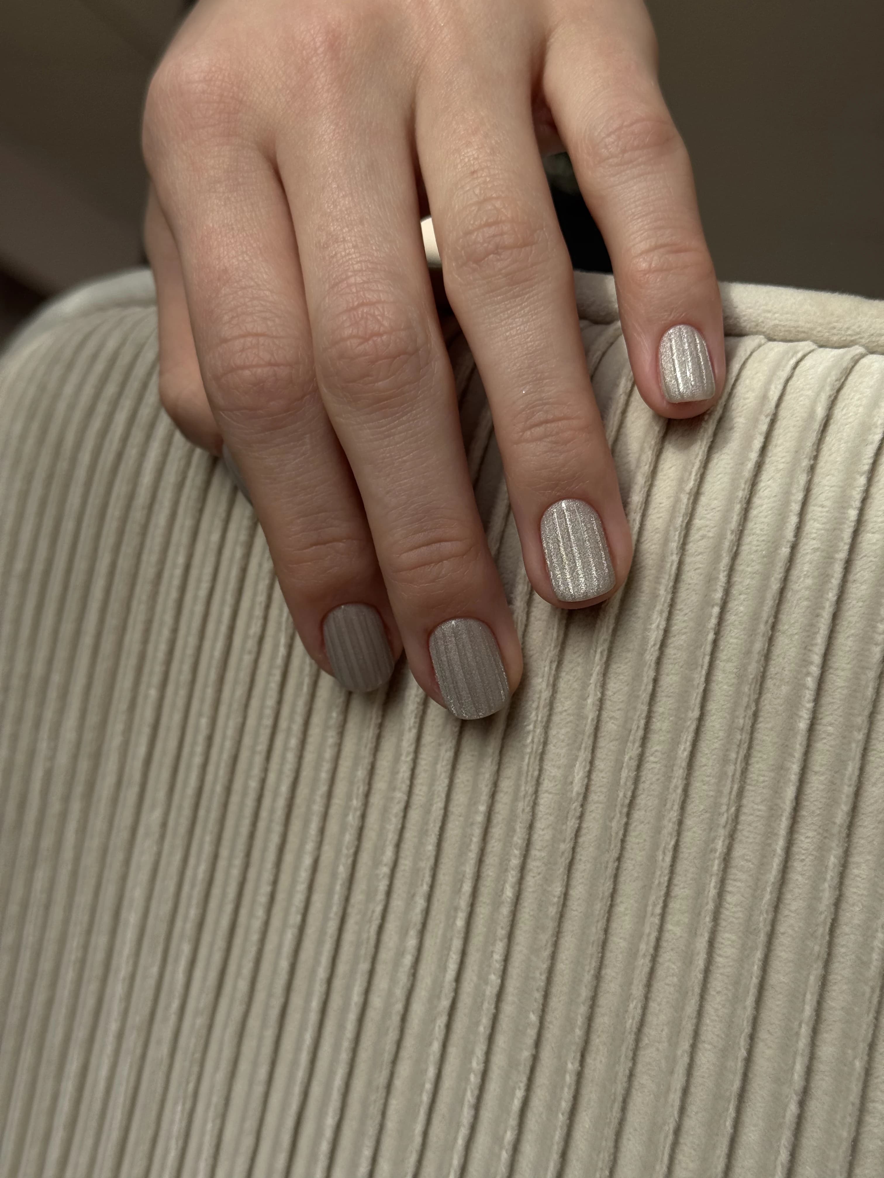 Champagne cat-eye nail art at My Beauty Space Mississauga on short squoval nails over beige ribbed fabric.