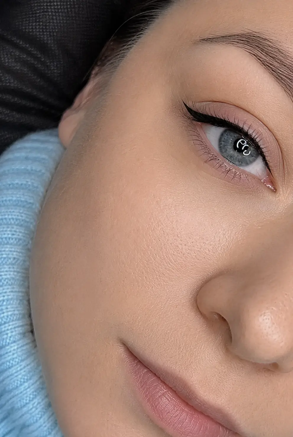 Crisp black winged permanent eyeliner on blue-grey eyes with ring-light detail at My Beauty Space Mississauga.